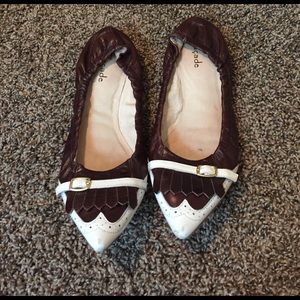 Brown and white buckle flats