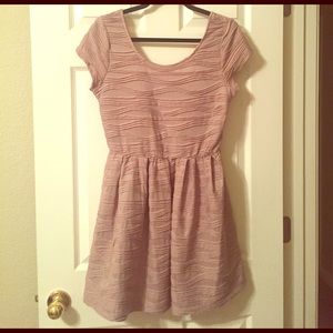 Playful beige dress with scooped back