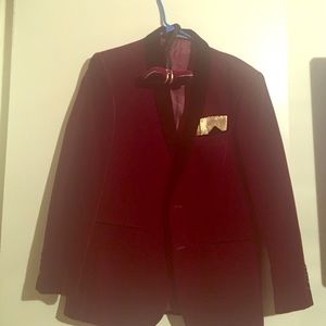 A burgundy velvet blazer and bow tie