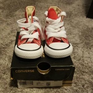 Red and white hightop Chuck Taylor's