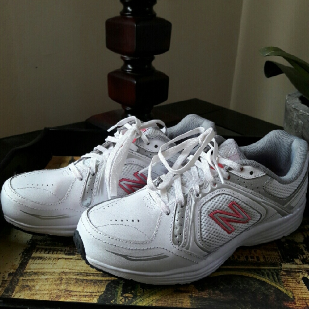 New Balance pink and white running sneakers.