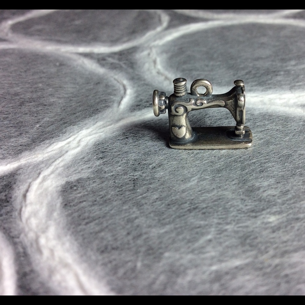 Vintage sewing machine charm.