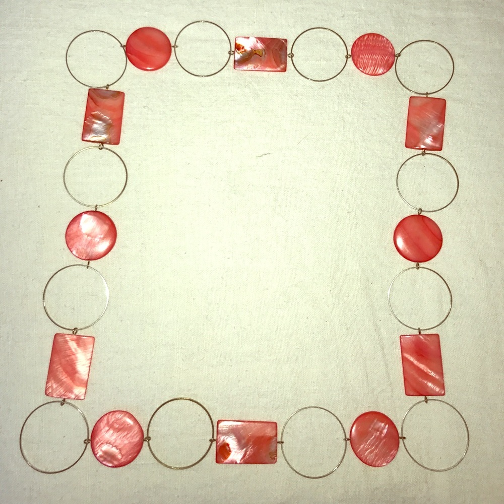 Coral-tone shell necklace with gold-tone hoops