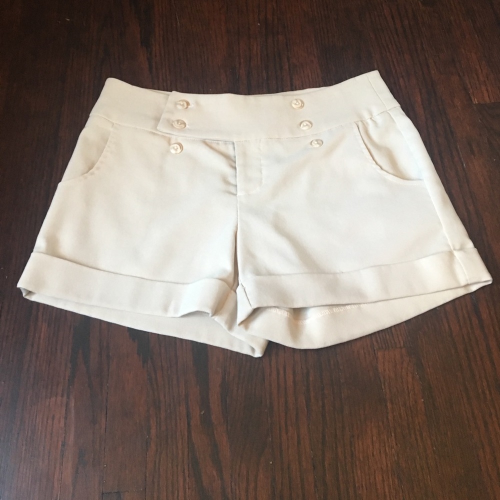 Cream colored shorts.
