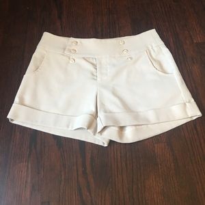 Cream colored shorts.