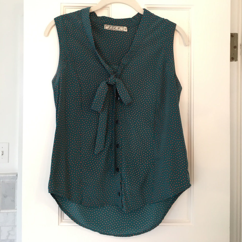 Green sleeveless blouse orange polka dots