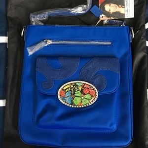 Debbie Brooks blue purse with butterfly detail.