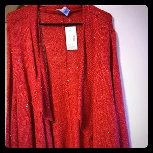 Red sweater with some sequence on it very pretty
