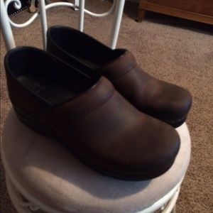 Brown, oiled leather dansko clogs. Lightly worn.