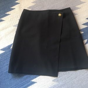 A-line skirt with brass button detail.