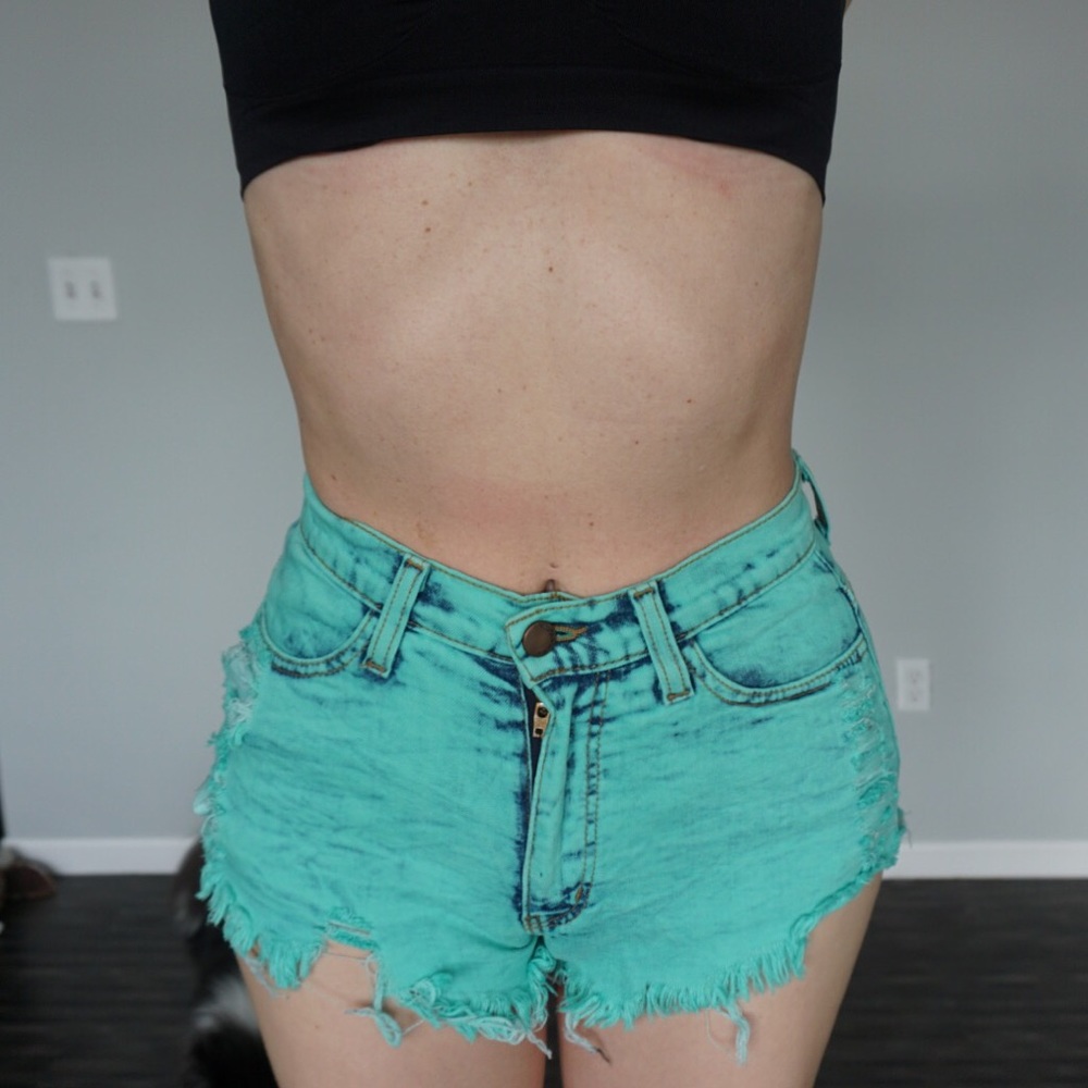High waisted teal destroyed denim shorts