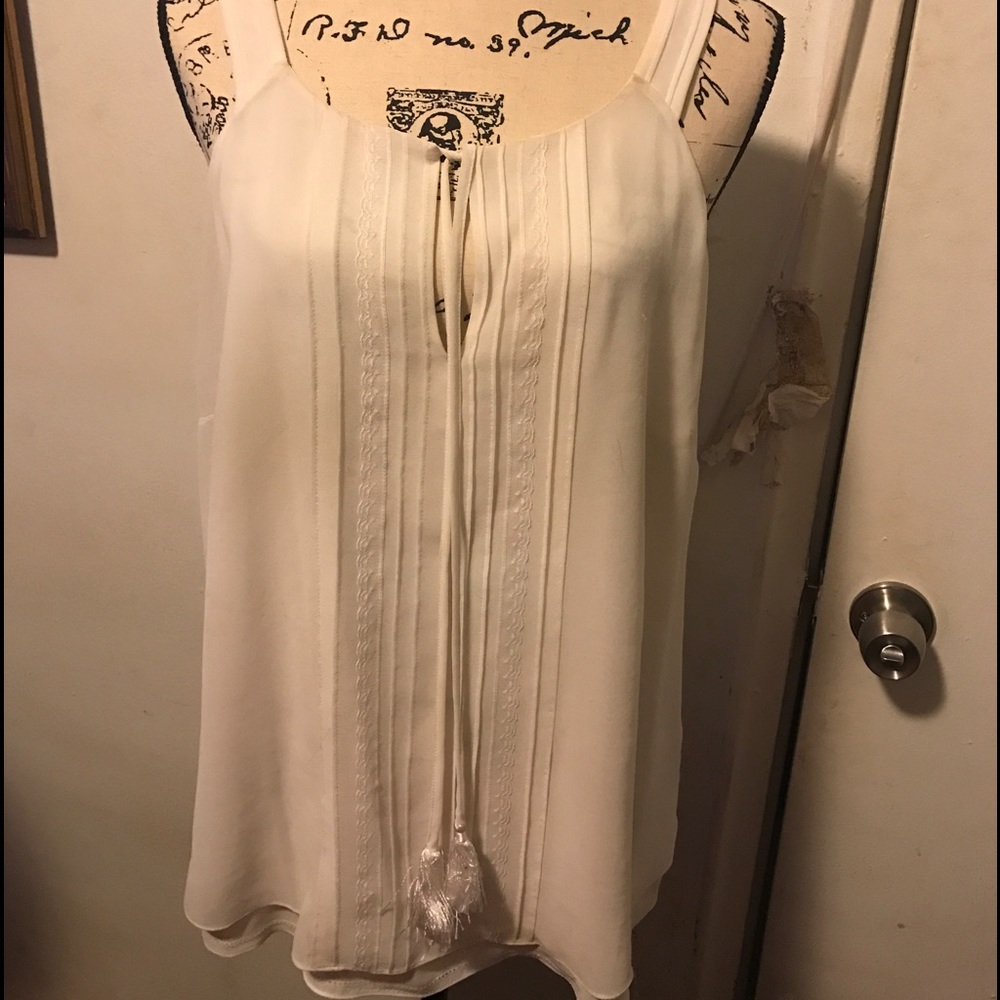 Cream colored sleeveless blouse