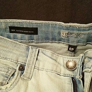 Distressed released hem skinny jean
