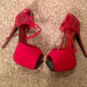Never worn pair of red and black heels
