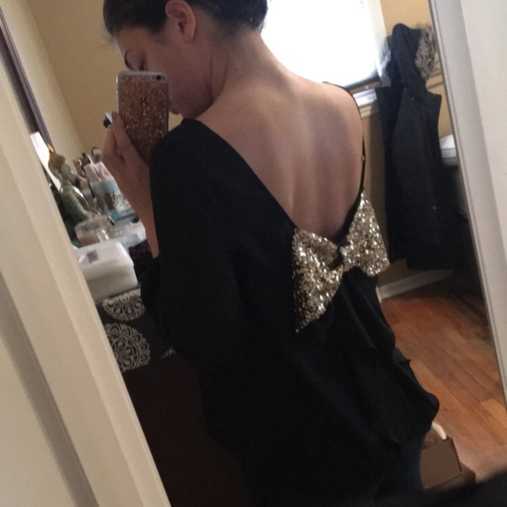 Low back black blouse with gold sequence bow