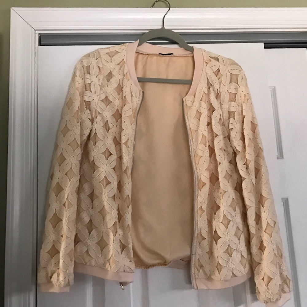 Lightweight beige jacket with silver zipper