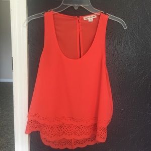 Super cute salmon colored top with an open back!
