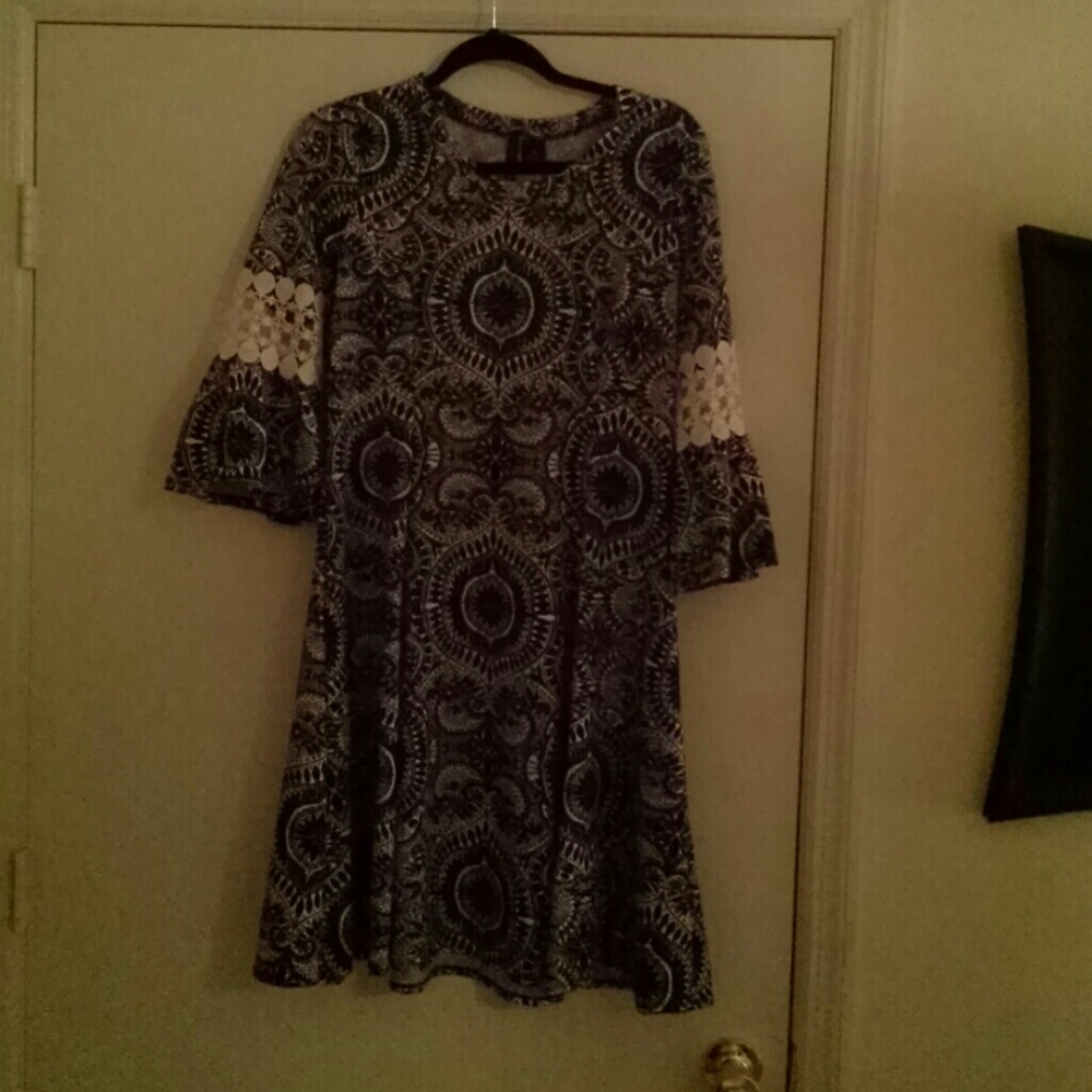 A navy blue dress with lace on the sleeves