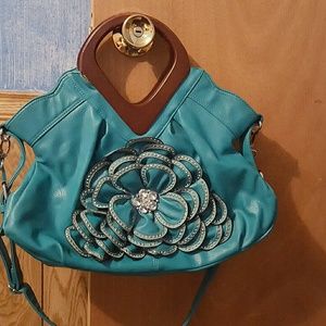 Teal purse with wooden handles. Flower w/jewels