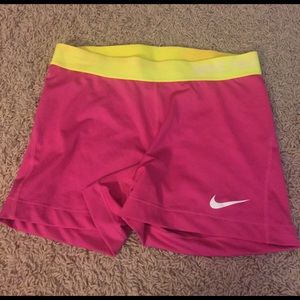 Adult large pink and neon yellow Nike Pros