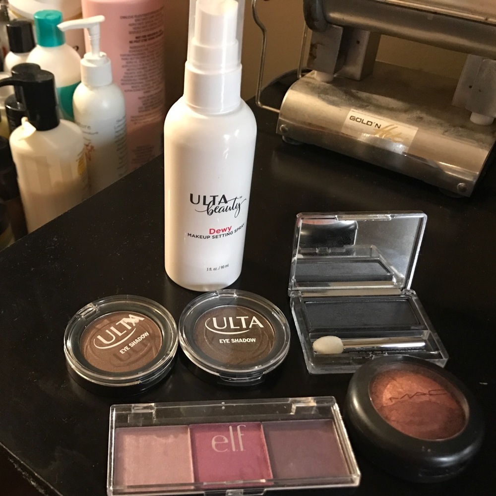 Various eyeshadows and makeup setting spray