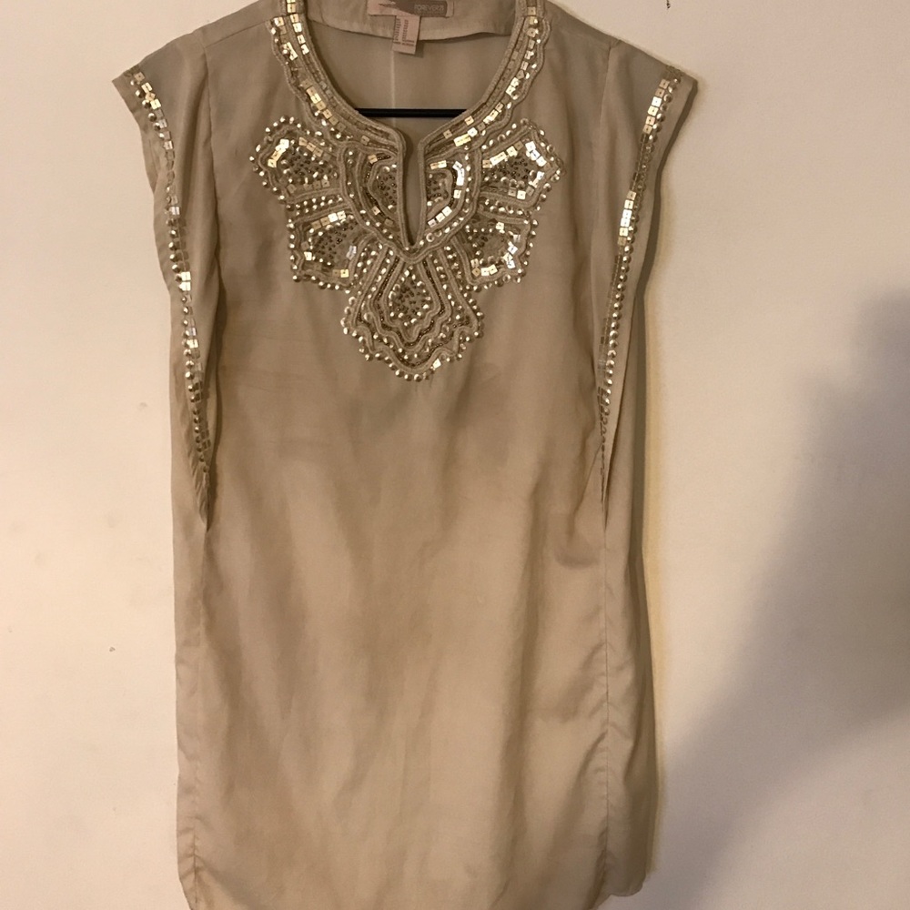 Gold sequined embellished dress or top.