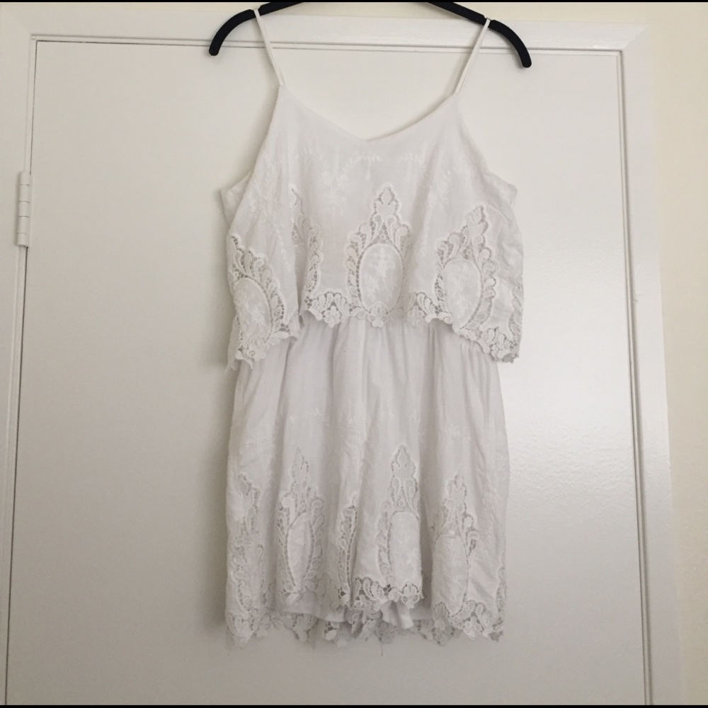 white romper with crochet details