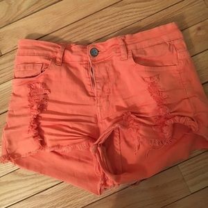 Salmon colored distressed jean shorts