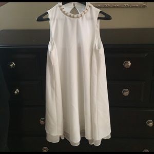 White A-line, high neck maternity dress.