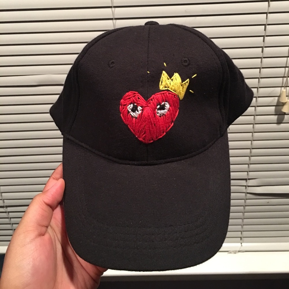 Black hat with heart and read eyes with a crown
