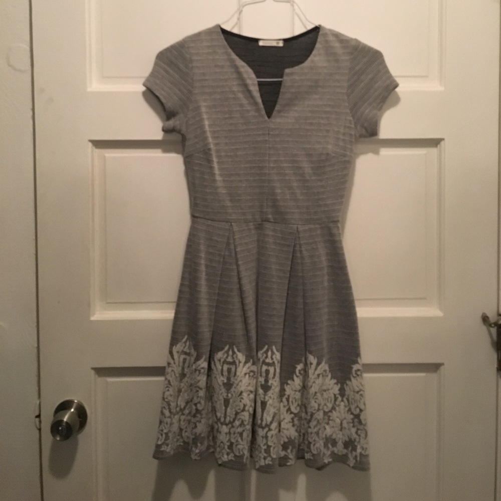 Cute gray dress with feminine pattern at bottom