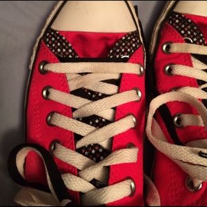 Pinkish red and black converse all stars