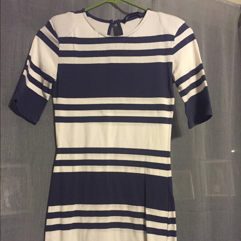 Cream and blue fitted dress with shoulder pads.