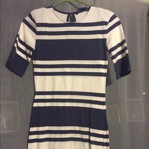 Cream and blue fitted dress with shoulder pads.