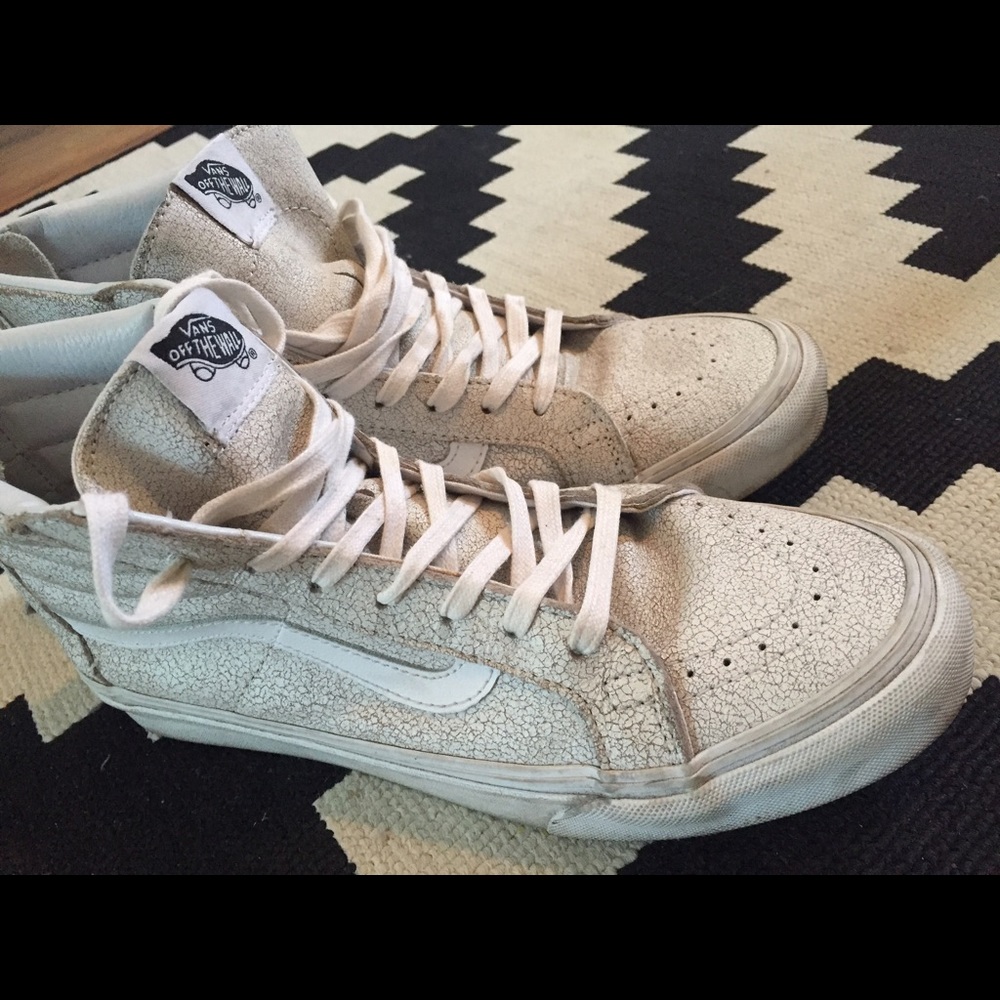 Cracked leather Vans high tops.