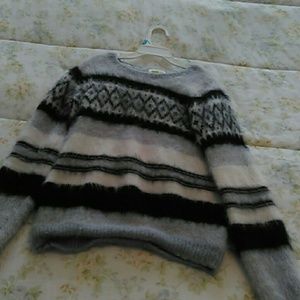 A black gray and White fluffy sweater.