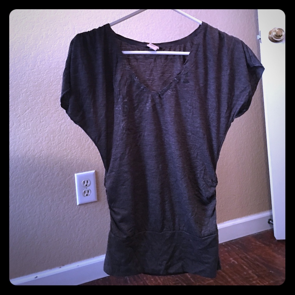 Small grey shirt that's tighter at the bottom.