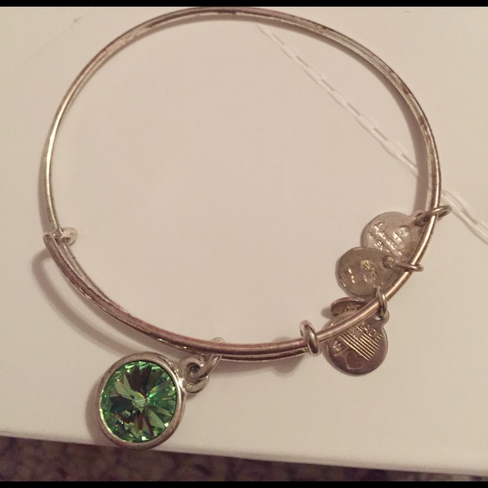 silver alex and ani bracelet with the green gem