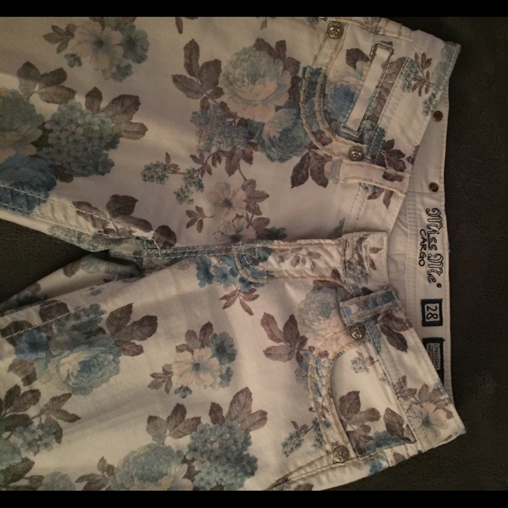 Blue floral jeans. Missing front button as shown.
