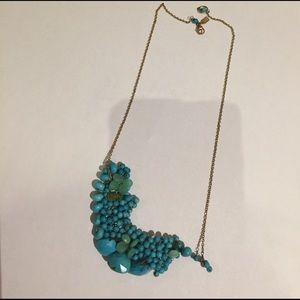 Alexis Bittar turquoise necklace with gold chain.