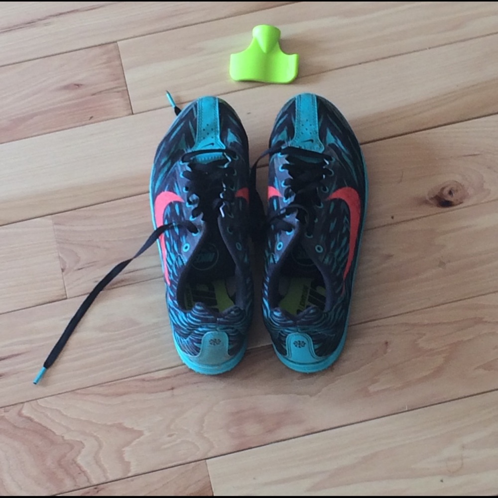 Teal and salmon colored track spikes/cleats