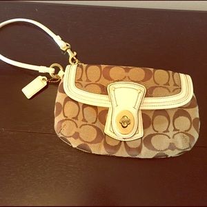 White and tan Coach wristlet