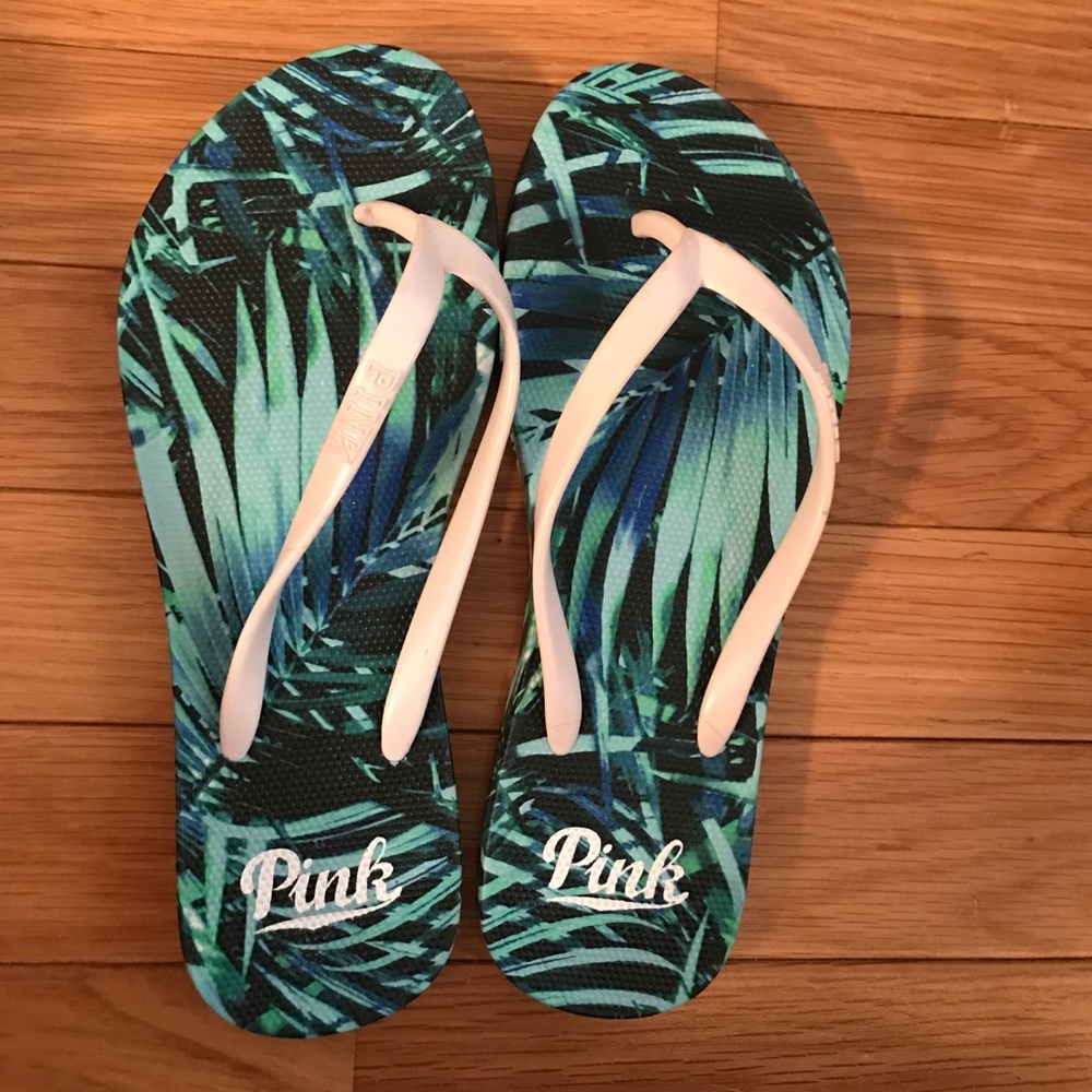PINK tropical flip flops.