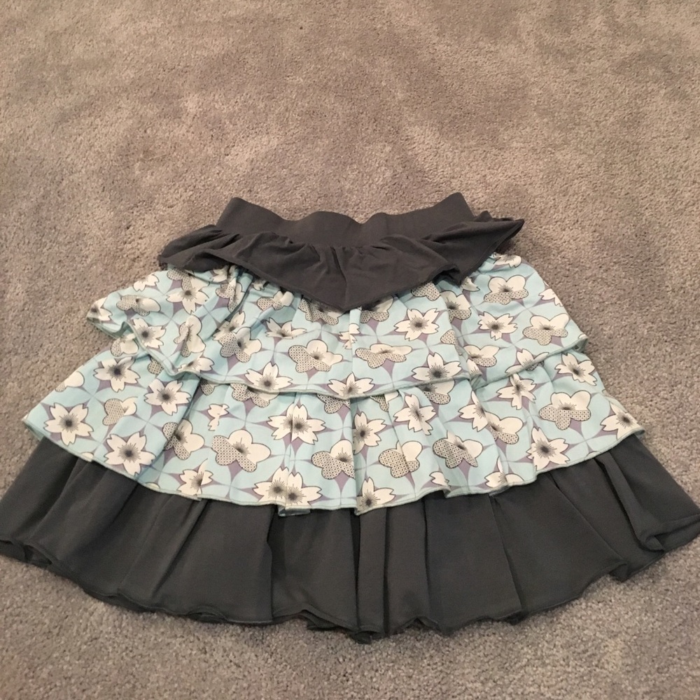 A skirt with light blue patterned and grey peplums