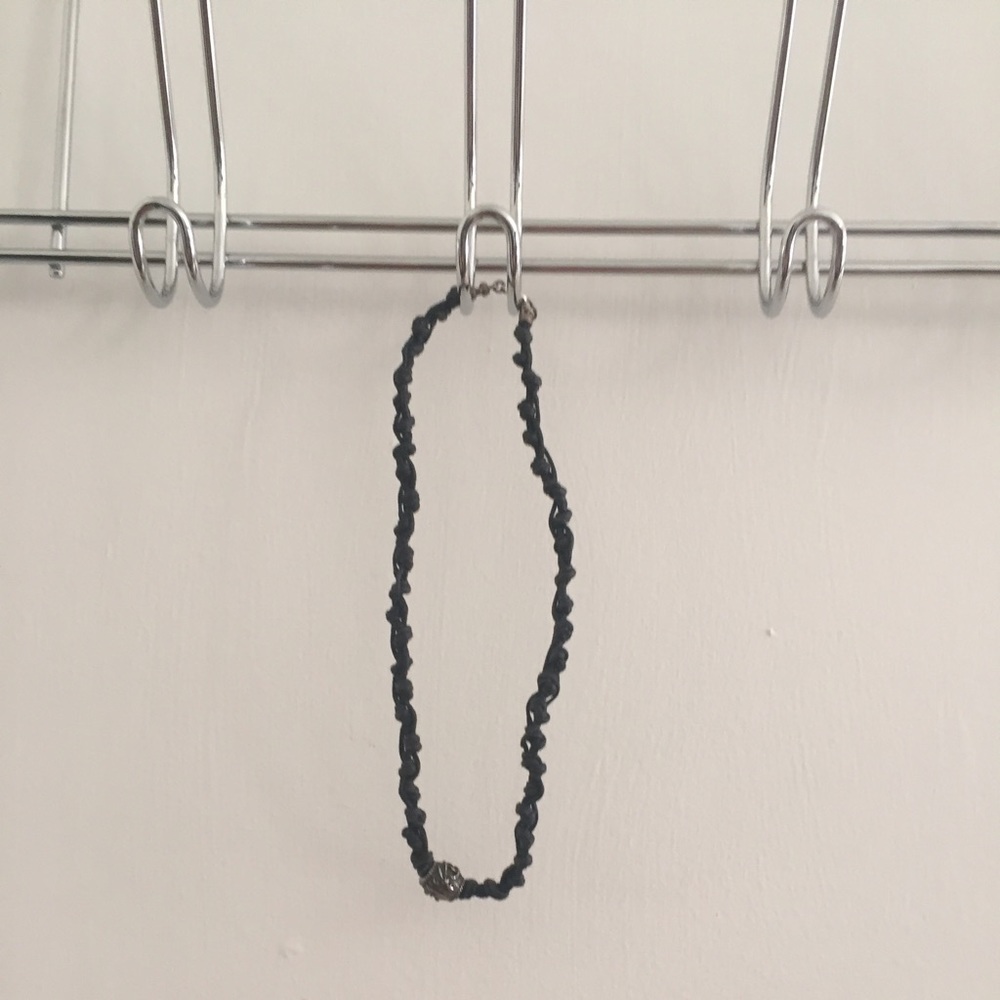 Hand-knotted leather necklace with metallic charm