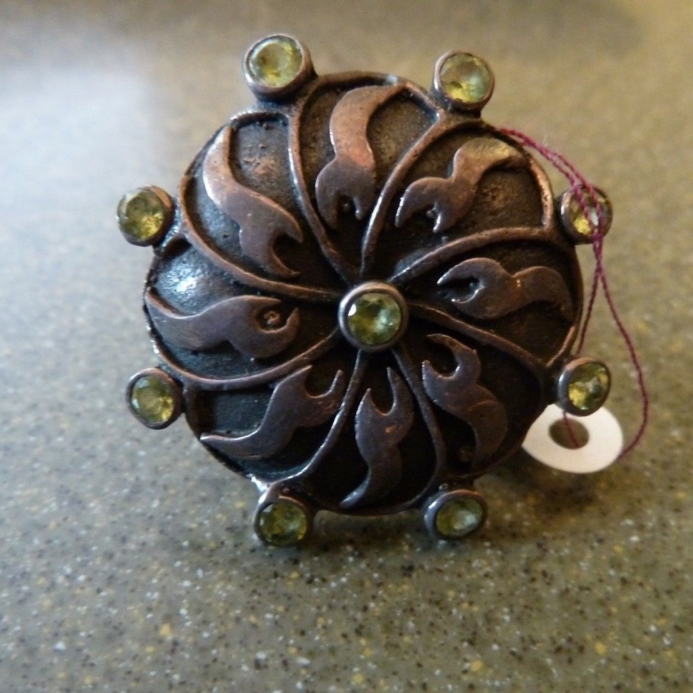 Flower ring made in Thailand with green gem accent