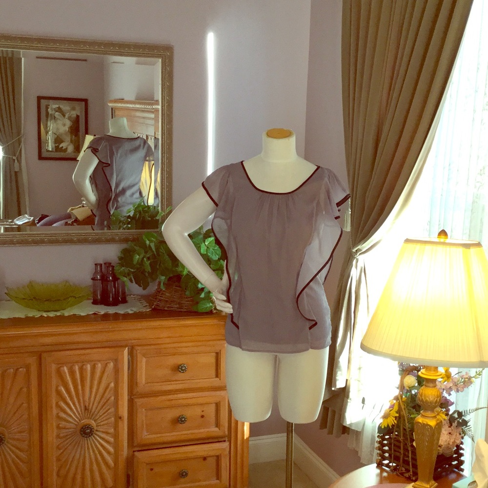 Flashy silver top with black piping