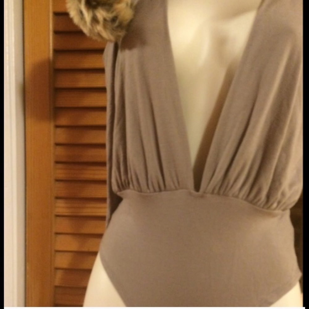 Beige open cut out shoulder deep v-neck bodysuit.