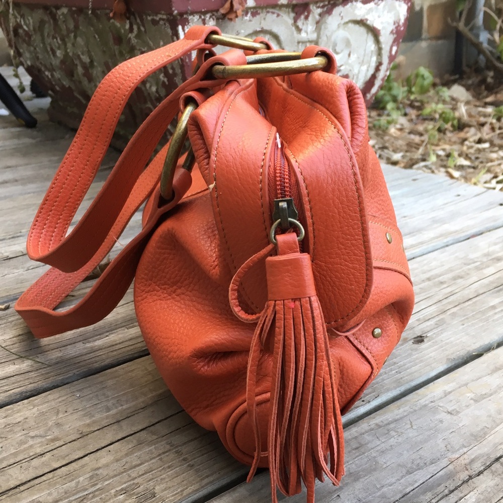 Slouchy Pebbled Leather tasseled, studded handbag.