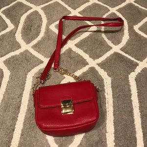 Small red purse with gold hardware.